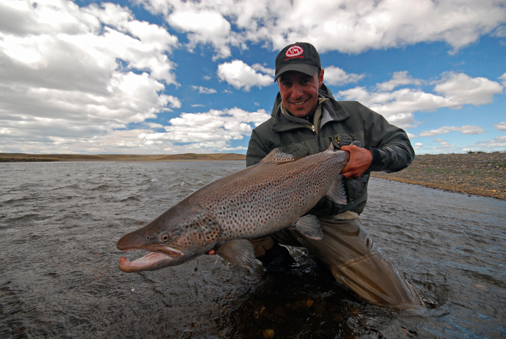 A happy fisherman with a perfectly conditioned cock fish