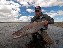 A happy fisherman with a perfectly conditioned cock fish