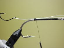 Take a length of Fireline and form a loop. Thread the loop through the eye of your stinger hook. Attach the Fireline above above the hook point. (NOTE: Make sure you make your loop long enough to remove the stinger hook. This will allow you to change