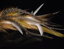 This is another replot stinger mack (II) tied with red and white raccoon fur, white Chinese  cock saddles & hot orange microbarb saddles