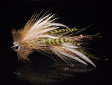This one is a combination of tan bucktail chartreuse grizzly schlappen, white microbarb saddles and a tightly spun deer hair head crimped together with a fish skull