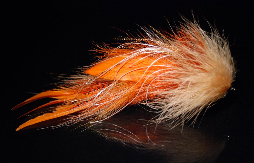 This is a combination of Orange schlappen, hot orange grizzly microbarb saddles,Tan floss Fibre and tan marabou hairline feathers