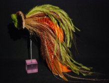 This one is a combination of orange and brown schlappen mixed with Olive ostrich herl and  tan bucktail. The head is a tightly packed spun deer hair head in tan dark brown and chartreuse