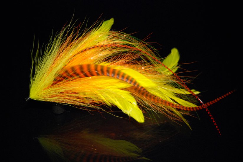 This is a combination of Yellow schlappen,hot orange grizzly microbarb saddles, Orance and  tan bucktail