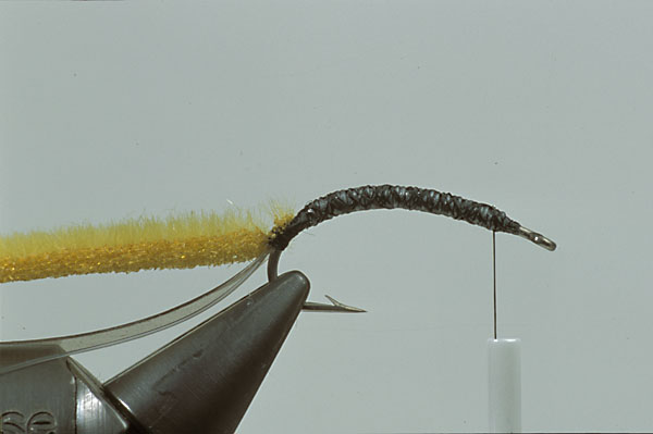 Step5  Tie in a narrow strip of Furry foam. If furry foam is not available use hare-tron or fine dubbing material