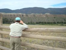 Fisherman looks across the Madison at the Palisades , where Blackfeet Indians used to drive herds of bison over the cliffs