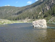 Deep trout-holding pool behind massive boulder in the Madison River