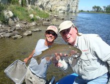 Guide Mike Spence holds rainbow trout caught by Steve Patterson