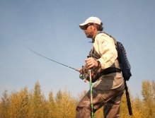 Working across the Elk with wading staff