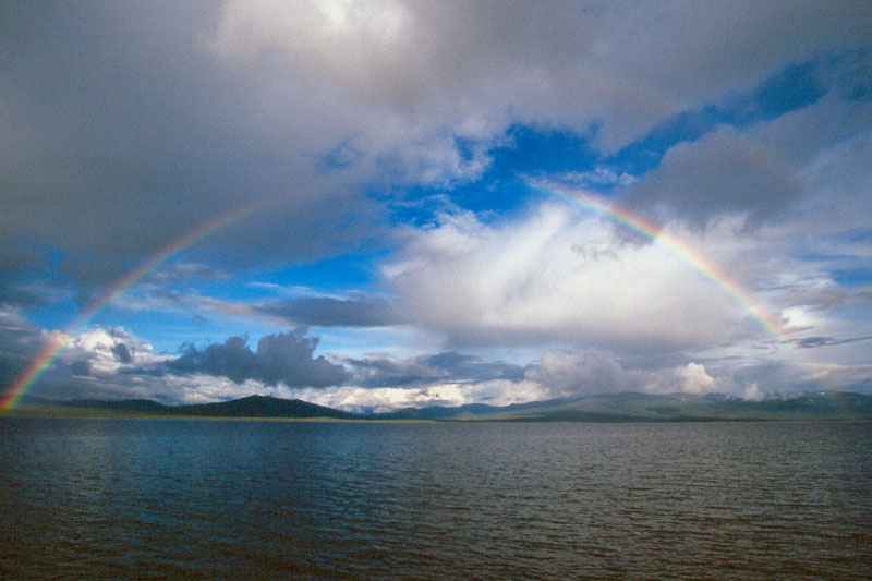 Entire rainbow over Wolf Lake,Yukon, Canada