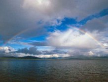 Entire rainbow over Wolf Lake ,Yukon, Canada
