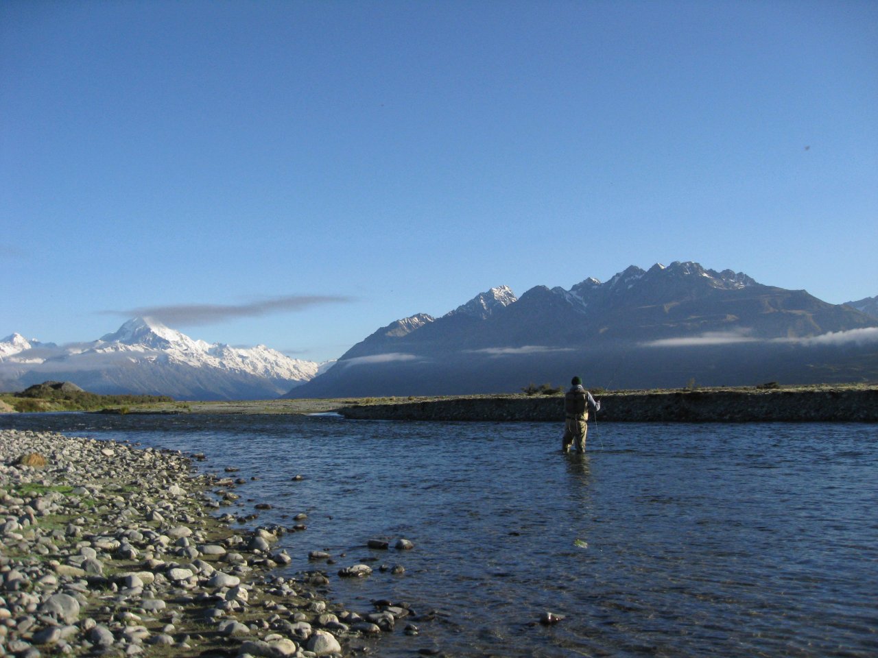 Casting flies at dawn under a snow-capped Mt.Cook