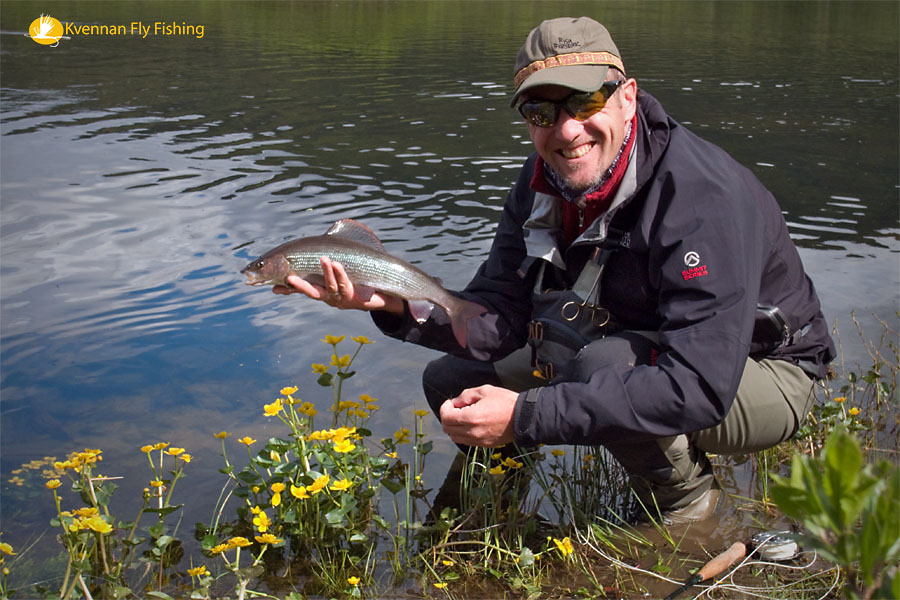 Happy fly fisherman with nice grayling