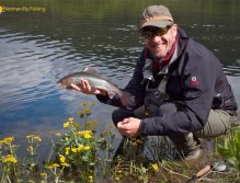 Happy fly fisherman with nice grayling